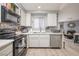 Modern kitchen boasting white cabinetry, stainless steel appliances, and sleek countertops, adjacent to a living area at 2240 Highpointe Dr # 203, Laughlin, NV 89029