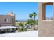 View of a neighborhood, showcasing houses, palm trees, and a glimpse of water and mountains in the background at 2240 Highpointe Dr # 203, Laughlin, NV 89029