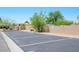 A parking lot with several parking spots available alongside a brick wall and landscaping at 2240 Highpointe Dr # 203, Laughlin, NV 89029