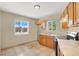 Cozy kitchen with light wood cabinets, tile floor, and a view of backyard at 2257 Colebrook St, Las Vegas, NV 89115