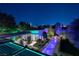 Night aerial view of luxury home with illuminated pool and city skyline at 2323 Pinto Ln, Las Vegas, NV 89107