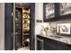 Custom bar area featuring unique storage, glass shelving, and a built-in beverage center at 2323 Pinto Ln, Las Vegas, NV 89107