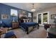 A cozy bedroom with a blue accent wall, ornate furnishings, and a decorative chandelier at 2323 Pinto Ln, Las Vegas, NV 89107