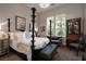 A stylish bedroom with a four-poster bed, decorative pillows, and elegant furnishings at 2323 Pinto Ln, Las Vegas, NV 89107