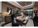 Formal dining area features a large table, chandelier, and a view of the pool area at 2323 Pinto Ln, Las Vegas, NV 89107