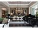 Spacious dining room with grand piano, statement lighting and stylish decor at 2323 Pinto Ln, Las Vegas, NV 89107