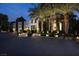 Luxurious two-story modern home featuring palm trees and a spacious paved driveway at 2323 Pinto Ln, Las Vegas, NV 89107
