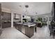 Open concept kitchen with large island, modern lighting, and seamless flow into the living room at 2323 Pinto Ln, Las Vegas, NV 89107