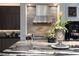 Close-up of gourmet kitchen with stainless steel appliances, unique backsplash, and marble countertops at 2323 Pinto Ln, Las Vegas, NV 89107