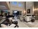 Bright living room boasts soaring ceilings, designer furnishings, a grand piano and a view of the pool at 2323 Pinto Ln, Las Vegas, NV 89107