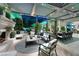 Elegant outdoor living space featuring a stone fireplace, comfortable seating, and views of the pool at 2323 Pinto Ln, Las Vegas, NV 89107