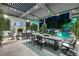 Expansive outdoor patio with fireplace, television, dining area, and a large pool with water features at 2323 Pinto Ln, Las Vegas, NV 89107