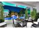 Covered outdoor patio with evening ambiance, views of the pool, and lush landscaping at 2323 Pinto Ln, Las Vegas, NV 89107