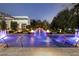 Backyard pool area with fountains, fire bowls, and manicured hedges at 2323 Pinto Ln, Las Vegas, NV 89107