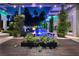Stunning pool area with lush landscaping, water features, and outdoor dining under a covered patio at 2323 Pinto Ln, Las Vegas, NV 89107
