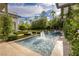 Tranquil pool area with fountains, manicured landscaping, and palm trees under a bright sky at 2323 Pinto Ln, Las Vegas, NV 89107