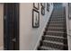 A carpeted staircase with decorative artwork and a dark wood door at 2323 Pinto Ln, Las Vegas, NV 89107