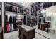 A luxurious walk-in closet with custom shelving, mirrored accents, and a central island for organization at 2323 Pinto Ln, Las Vegas, NV 89107