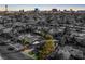 An aerial view shows the home nestled in a vibrant Las Vegas neighborhood with city skyline in the background at 2617 Mason Ave, Las Vegas, NV 89102