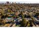 An elevated view of a community with mature trees and various houses, with the city skyline in the distance at 2617 Mason Ave, Las Vegas, NV 89102