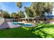 Beautiful backyard oasis featuring lush artificial turf, an in-ground pool, and mature trees offering shade at 2617 Mason Ave, Las Vegas, NV 89102