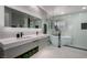 This bathroom features a dual sink vanity with marble countertop, soaking tub, and modern fixtures at 2617 Mason Ave, Las Vegas, NV 89102