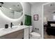 Bathroom featuring a vessel sink, illuminated round mirror, and access to the adjacent bedroom at 2617 Mason Ave, Las Vegas, NV 89102