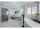 This bathroom features a soaking tub, walk-in shower with glass enclosure and dual sink vanity at 2617 Mason Ave, Las Vegas, NV 89102