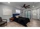 Bedroom featuring a dark bed, ceiling fan, sliding closet doors, and light gray walls at 2617 Mason Ave, Las Vegas, NV 89102