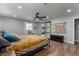 Bright bedroom with wood floors, large windows, ceiling fan, sitting area, and ensuite bathroom at 2617 Mason Ave, Las Vegas, NV 89102