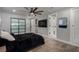 Bedroom featuring a dark bed, ceiling fan, sliding closet doors, and light gray walls at 2617 Mason Ave, Las Vegas, NV 89102