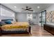 Bright bedroom with wood floors, large windows, ceiling fan, sitting area, and ensuite bathroom at 2617 Mason Ave, Las Vegas, NV 89102