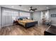 Bright bedroom with wood floors, large windows, ceiling fan, sitting area, and ensuite bathroom at 2617 Mason Ave, Las Vegas, NV 89102