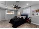 Bedroom featuring a dark bed, ceiling fan, sliding closet doors, and light gray walls at 2617 Mason Ave, Las Vegas, NV 89102