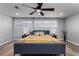 This bedroom features wood flooring, windows with curtains, ceiling fan and a brightly patterned bed spread at 2617 Mason Ave, Las Vegas, NV 89102