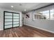 Bright bedroom featuring hardwood floors, a sliding-door closet, and a large window with natural light at 2617 Mason Ave, Las Vegas, NV 89102