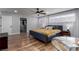 This bedroom features wood flooring, ceiling fan, windows with curtains, closet with shelving and organizers at 2617 Mason Ave, Las Vegas, NV 89102