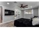 Bedroom featuring a dark bed, ceiling fan, sliding closet doors, and light gray walls at 2617 Mason Ave, Las Vegas, NV 89102