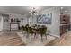 Stylish dining room with seating for eight, modern lighting, and a view into the kitchen at 2617 Mason Ave, Las Vegas, NV 89102
