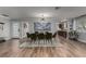 Modern dining room with a glass table, seating for eight, and stylish lighting at 2617 Mason Ave, Las Vegas, NV 89102