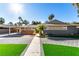 Inviting single-story home with carport, desert landscaping, and brick-paved driveway at 2617 Mason Ave, Las Vegas, NV 89102