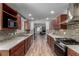 Updated kitchen boasts wood floors, quartz countertops, stainless steel appliances, and open layout at 2617 Mason Ave, Las Vegas, NV 89102