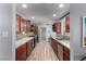 Modern kitchen boasts wood floors, quartz countertops, backsplash, and stainless steel appliances at 2617 Mason Ave, Las Vegas, NV 89102