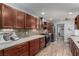 Modern kitchen boasts wood floors, quartz countertops, backsplash, and stainless steel appliances at 2617 Mason Ave, Las Vegas, NV 89102