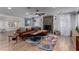 Cozy living room area with a stone fireplace, leather couch, and decorative rug on hardwood floors at 2617 Mason Ave, Las Vegas, NV 89102
