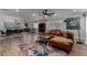 Bright living room featuring a comfortable brown leather couch and a unique floral rug at 2617 Mason Ave, Las Vegas, NV 89102