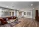 Inviting living room showcases hardwood floors, large windows with sheer curtains, and cozy seating for a relaxing atmosphere at 2617 Mason Ave, Las Vegas, NV 89102