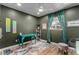 This office features a decorative turquoise desk, window with decorative curtains, ceiling fan, and wooden floors at 2617 Mason Ave, Las Vegas, NV 89102