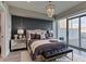 This bedroom offers a luxurious feel with a decorative light fixture, bench and terrace access at 2700 Las Vegas Blvd # 505, Las Vegas, NV 89109