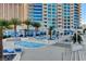 Resort-style pool and hot tub area with lounge seating and lush palm trees at a modern condominium building at 2700 Las Vegas Blvd # 505, Las Vegas, NV 89109